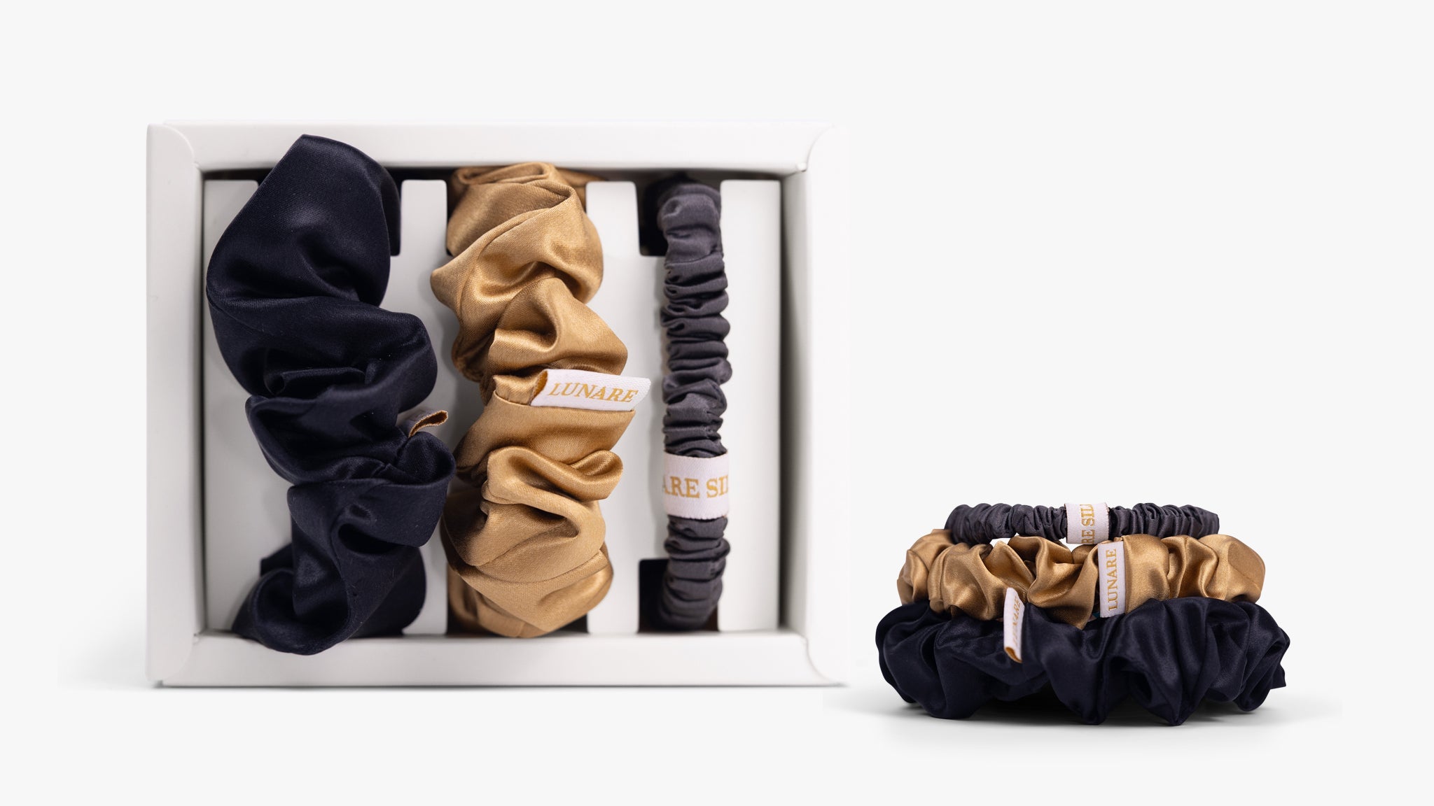 Classic neutral silk scrunchies in open gift box on white background