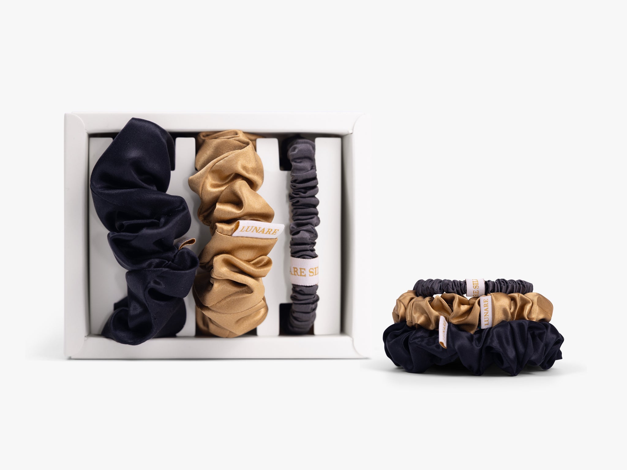 Classic neutral silk scrunchies in open gift box on white background