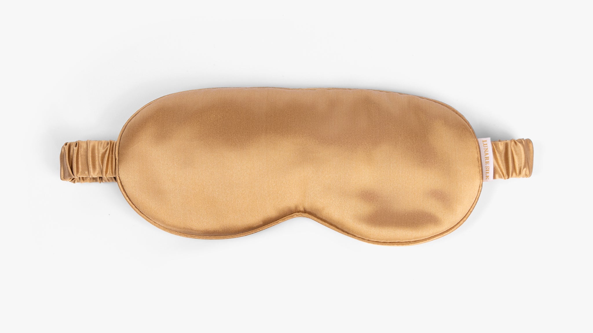 Amber gold mulberry silk eye mask on white background