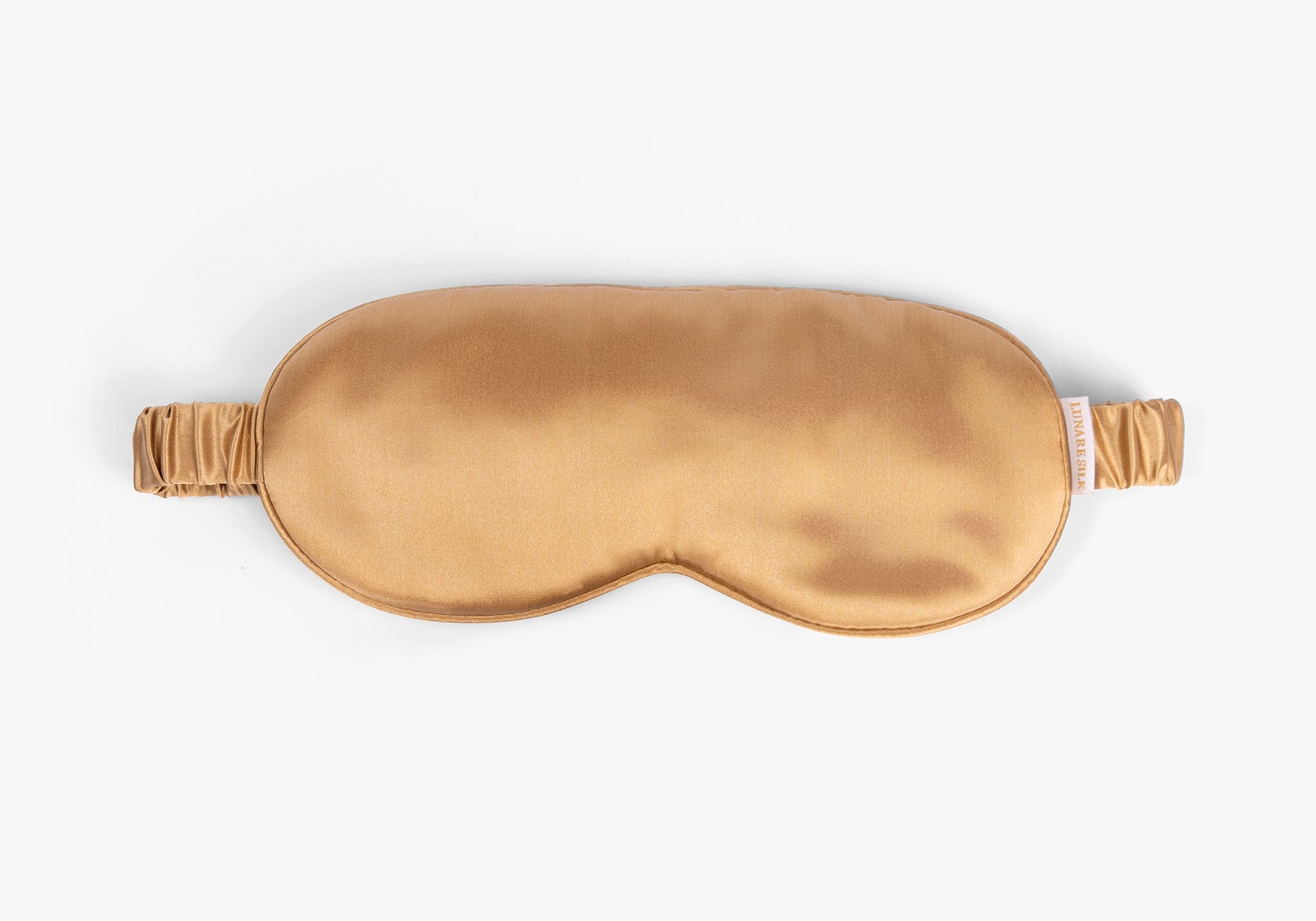 Amber gold mulberry silk eye mask on white background