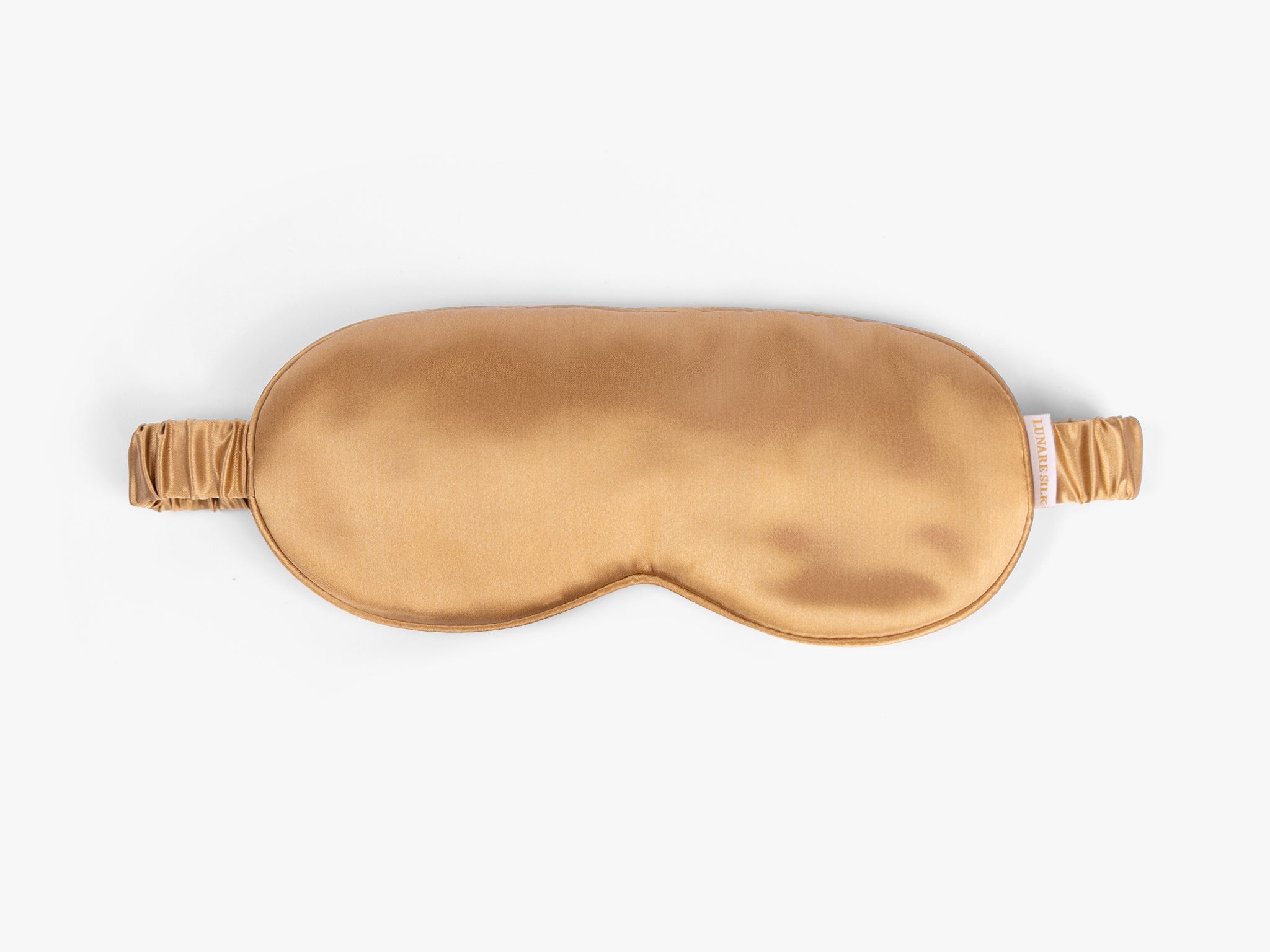 Amber gold mulberry silk eye mask on white background
