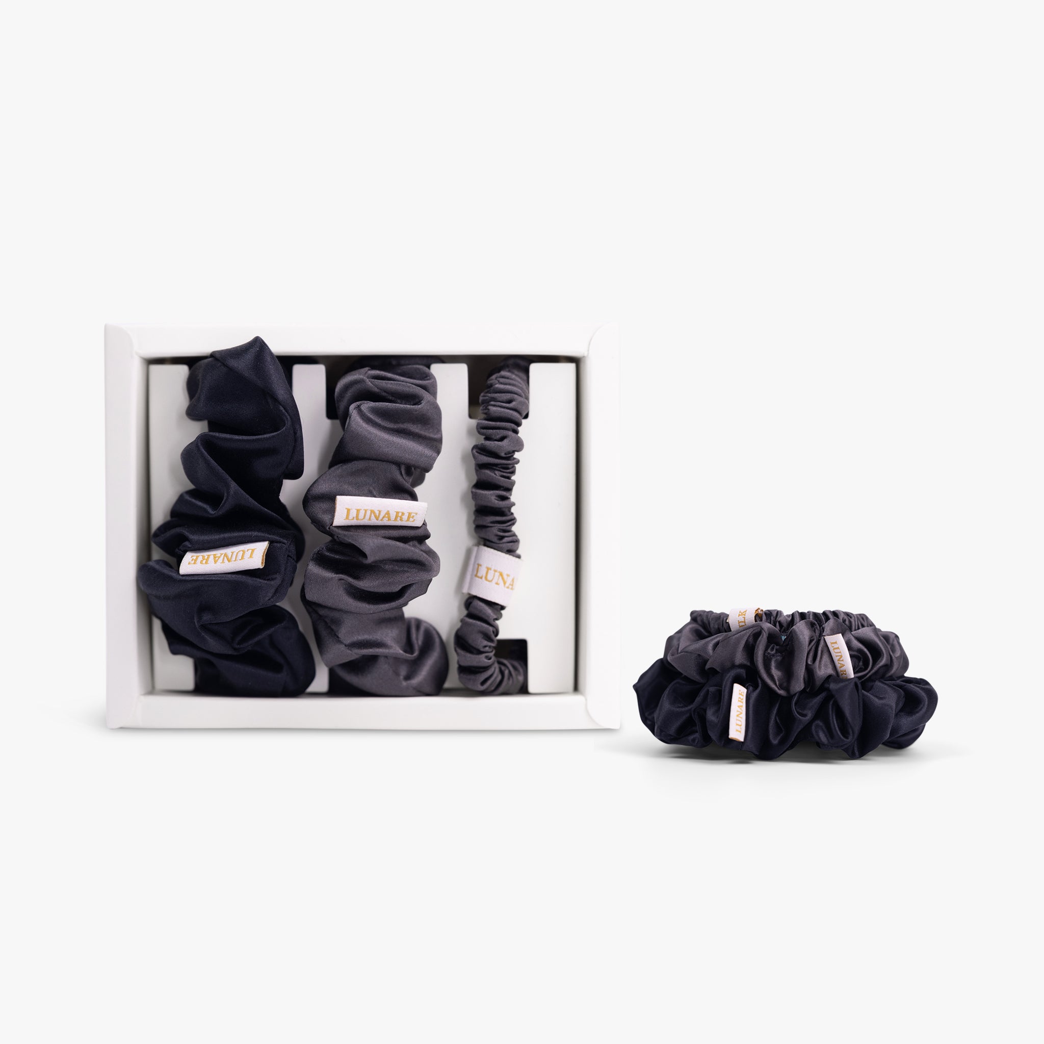 Deep neutral silk scrunchies set on white background
