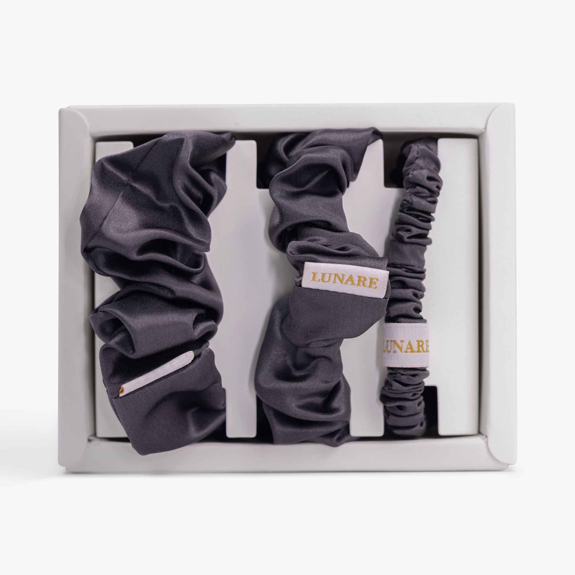 Dark grey silk scrunchies set in open box top view
