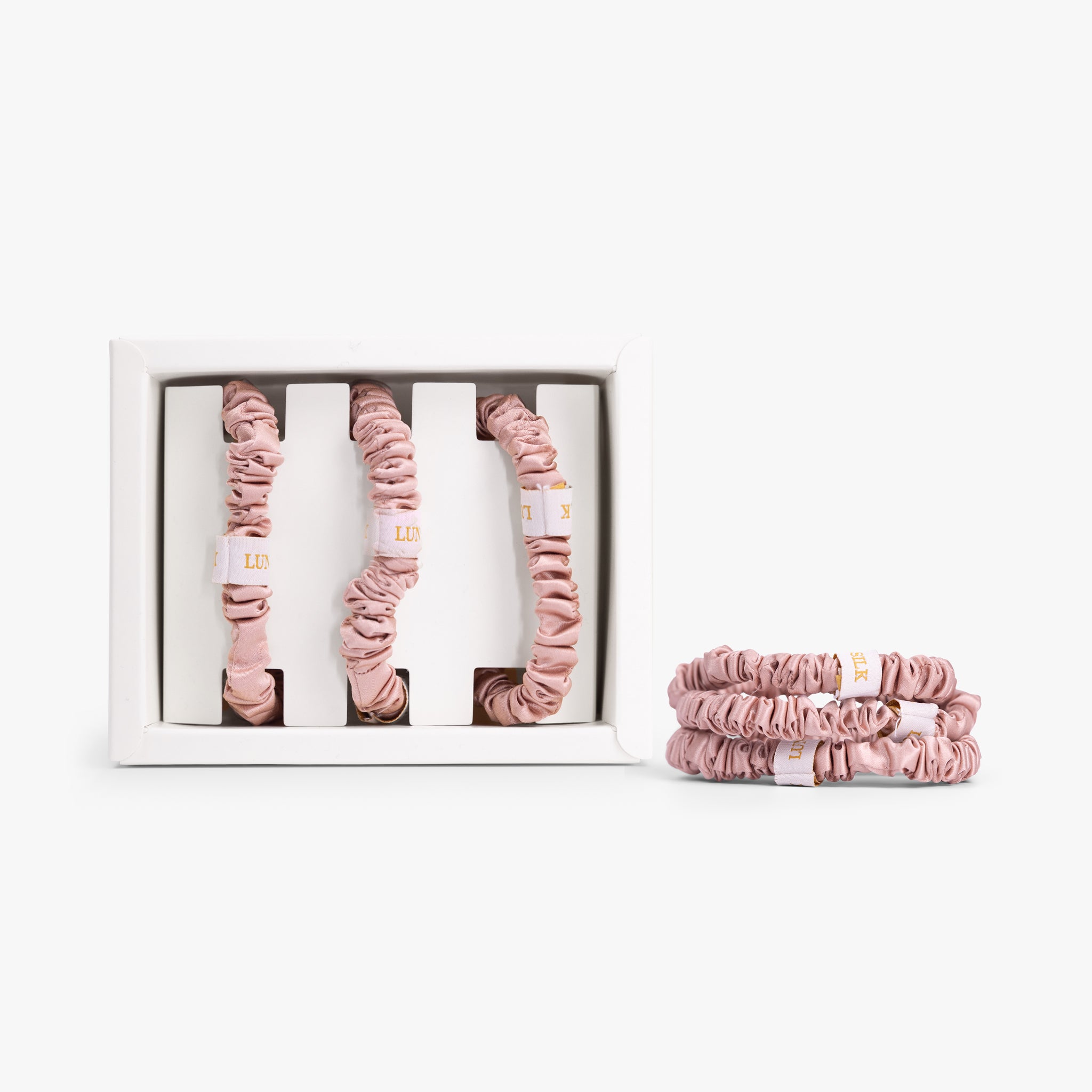 Rose gold small silk scrunchies with gift box and display on white background
