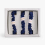 Set of three navy  blue scrunchies in a white box with LUNARE SILK branding.