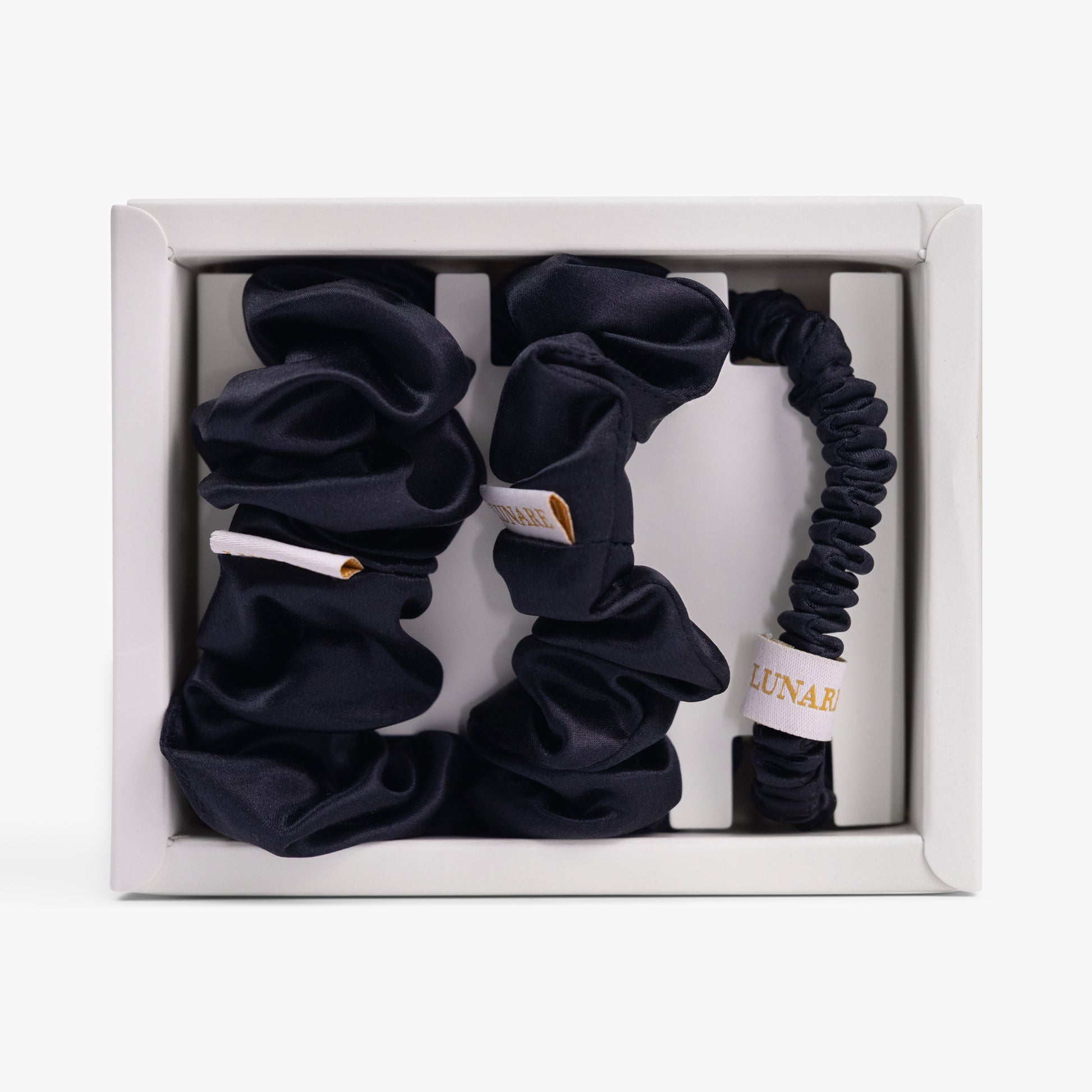 Black silk scrunchies set in open box top view

