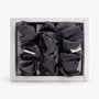Dark grey large silk scrunchie in open box top view
