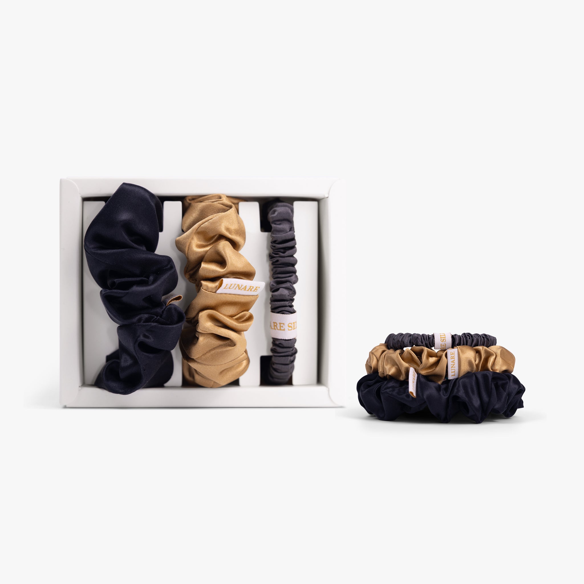 Classic neutral silk scrunchies in open box with stacked set on white background
