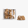 Amber gold silk scrunchies in open box with stacked set on white background
