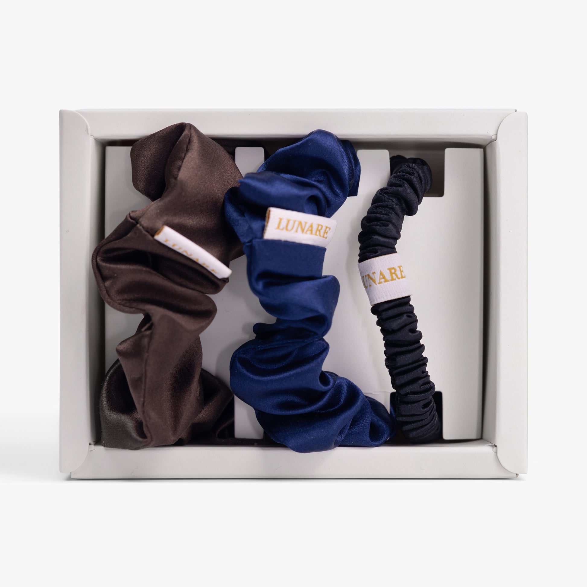 Dark neutral silk scrunchies set in open box top view
