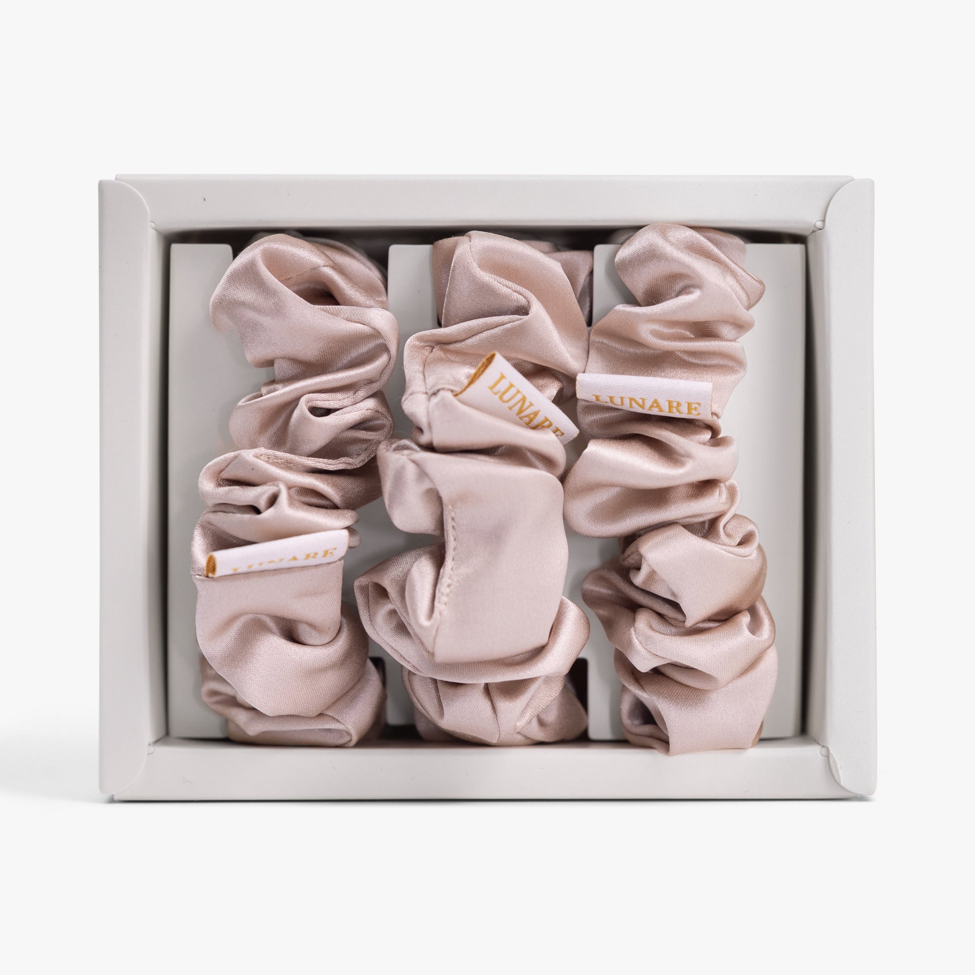 Champagne large silk scrunchie in open box top view
