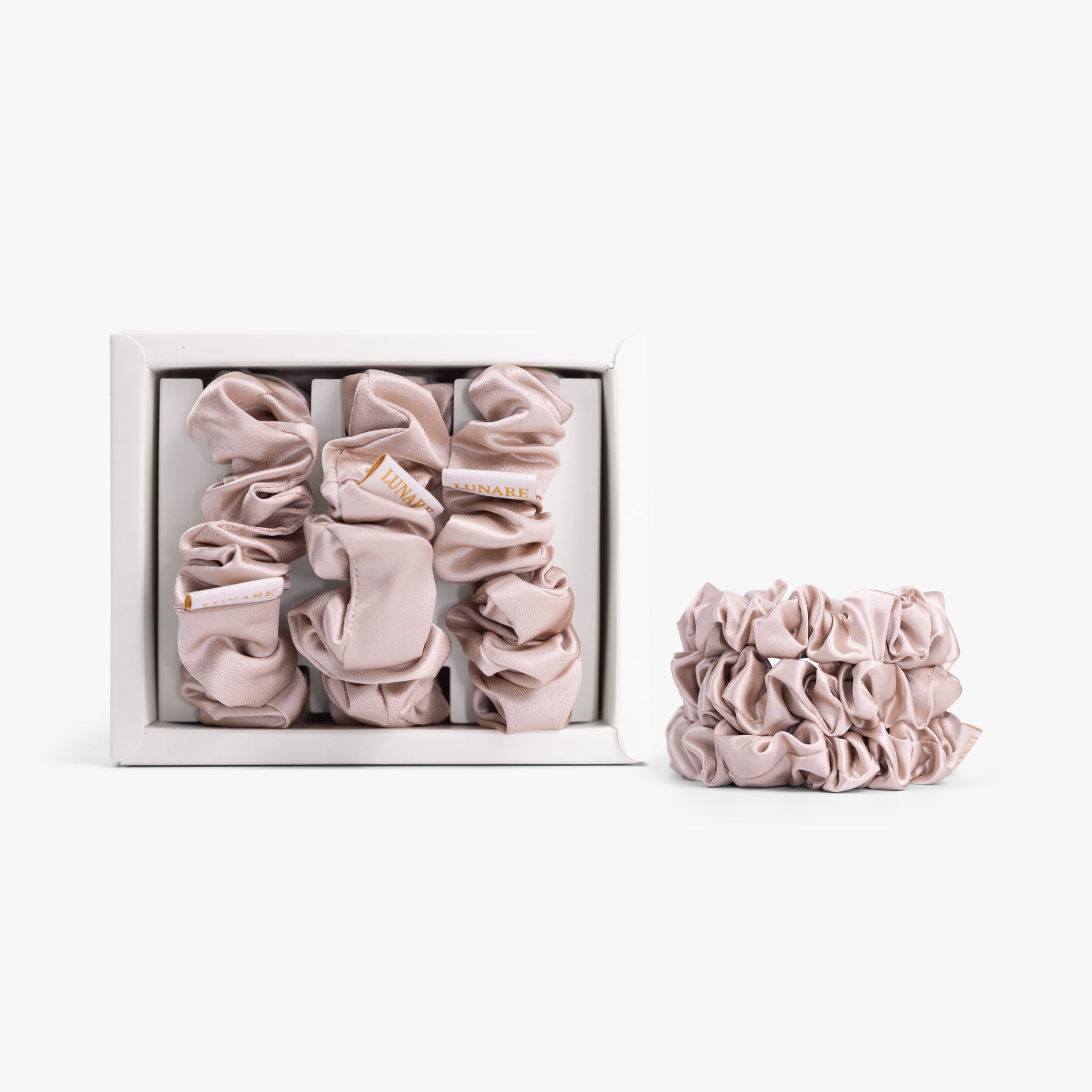 Champagne large silk scrunchie in open box on white background
