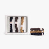 Set  of small hair ties in a box with additional hair ties displayed on a white background