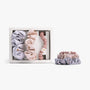 Soft neutral silk scrunchies in open box with stacked set on white background
