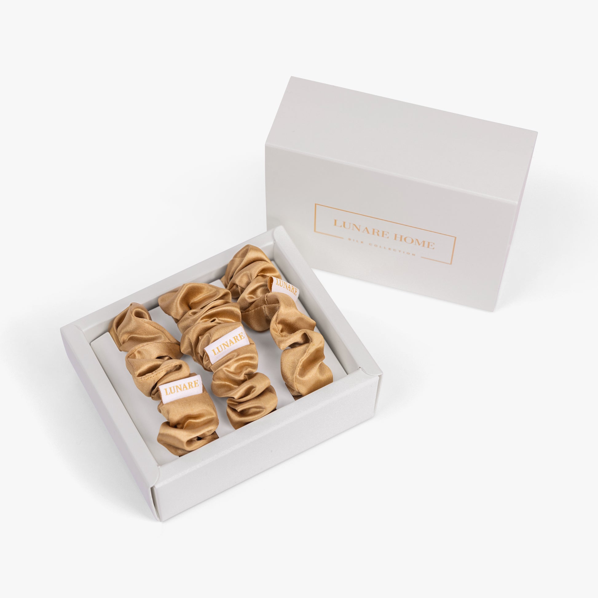 Amber gold large silk scrunchie in open gift box with Lunare Home lid
