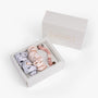 Soft neutral silk scrunchies in open gift box with Lunare Home lid
