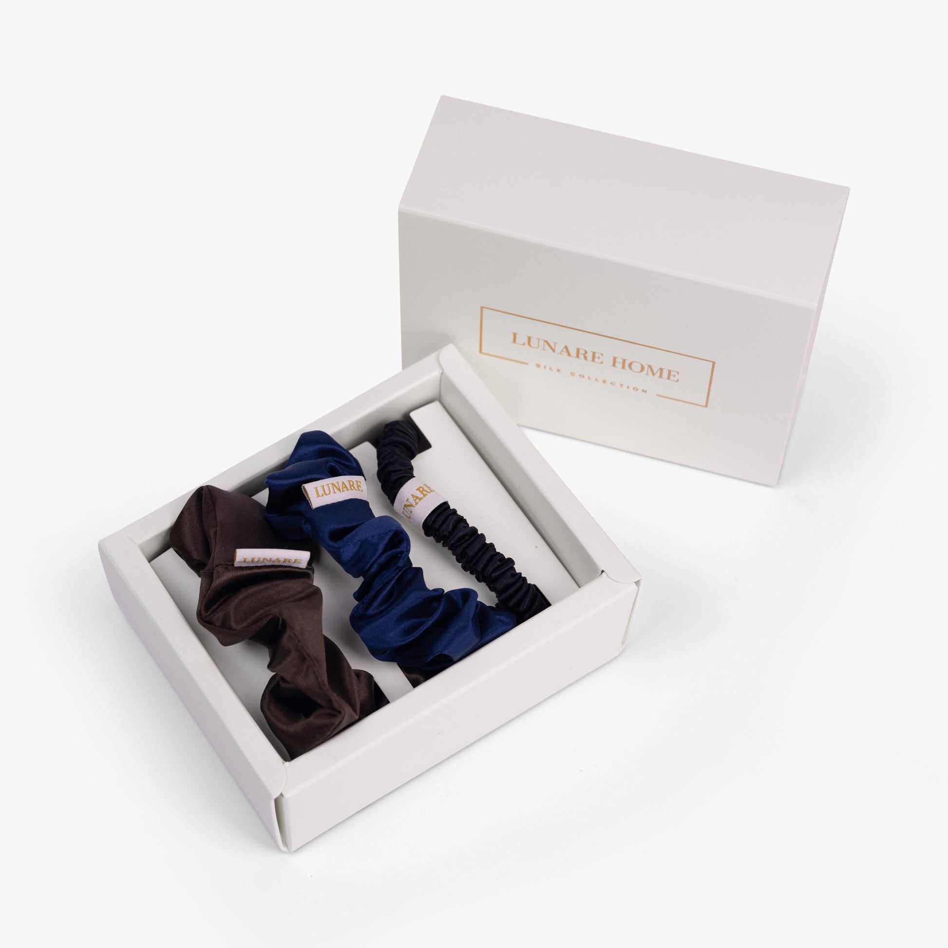 Dark neutral silk scrunchies in open gift box with Lunare Home lid
