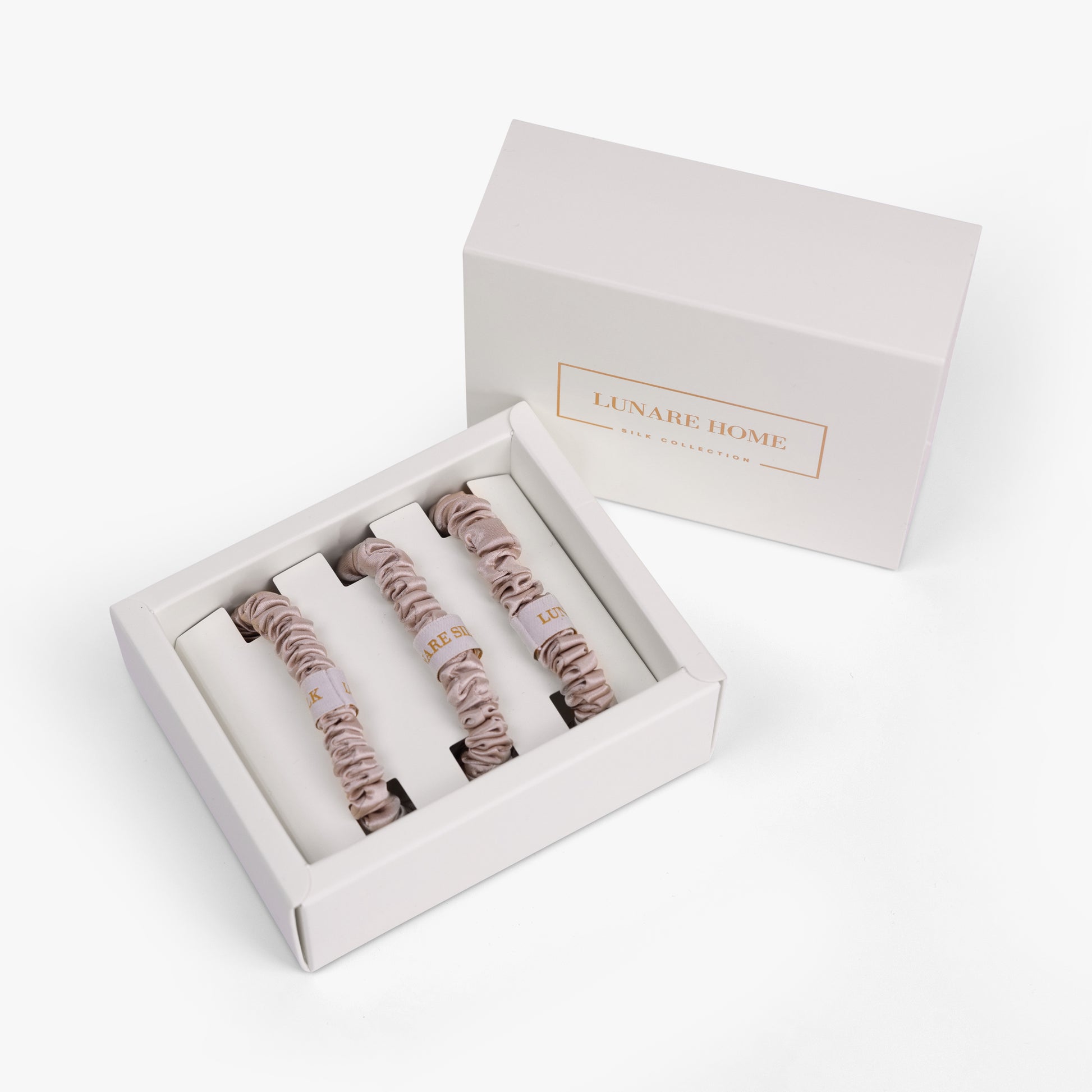 Set of hair ties in a branded box on a white background