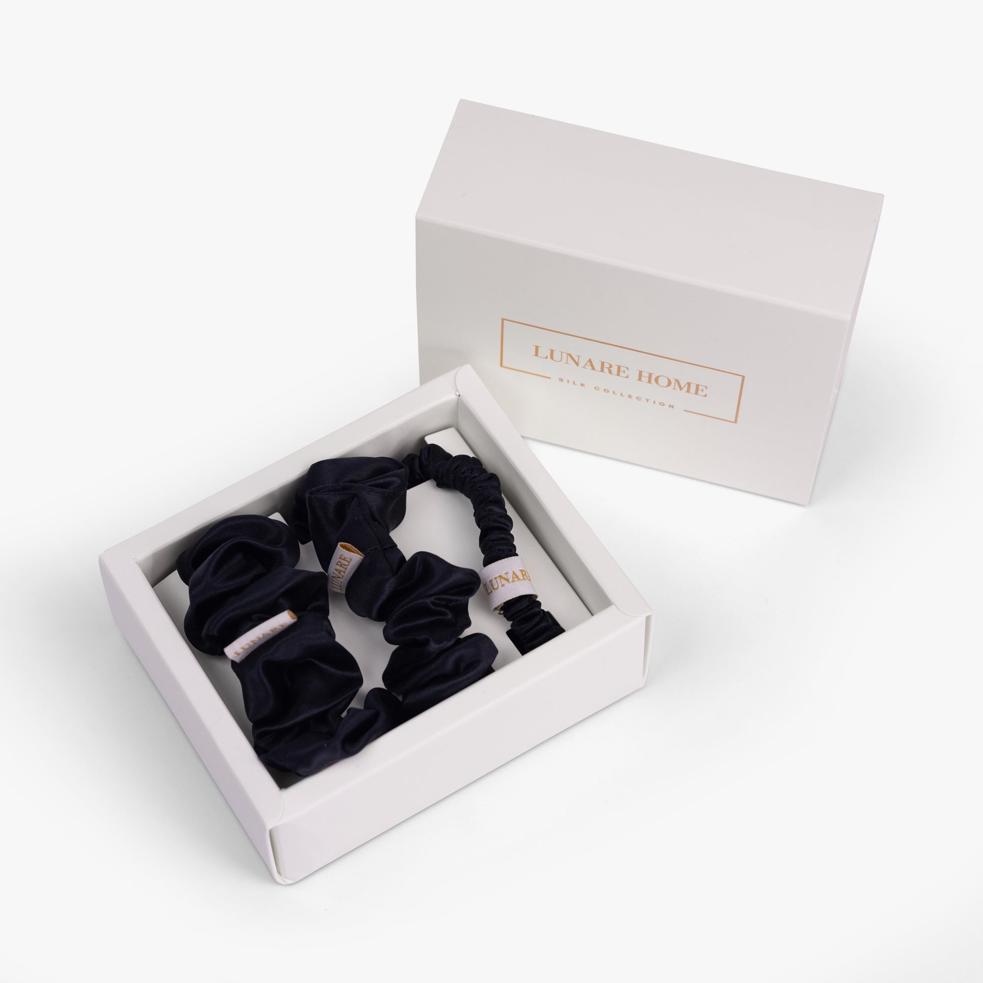 Black silk scrunchies in open gift box with Lunare Home lid
