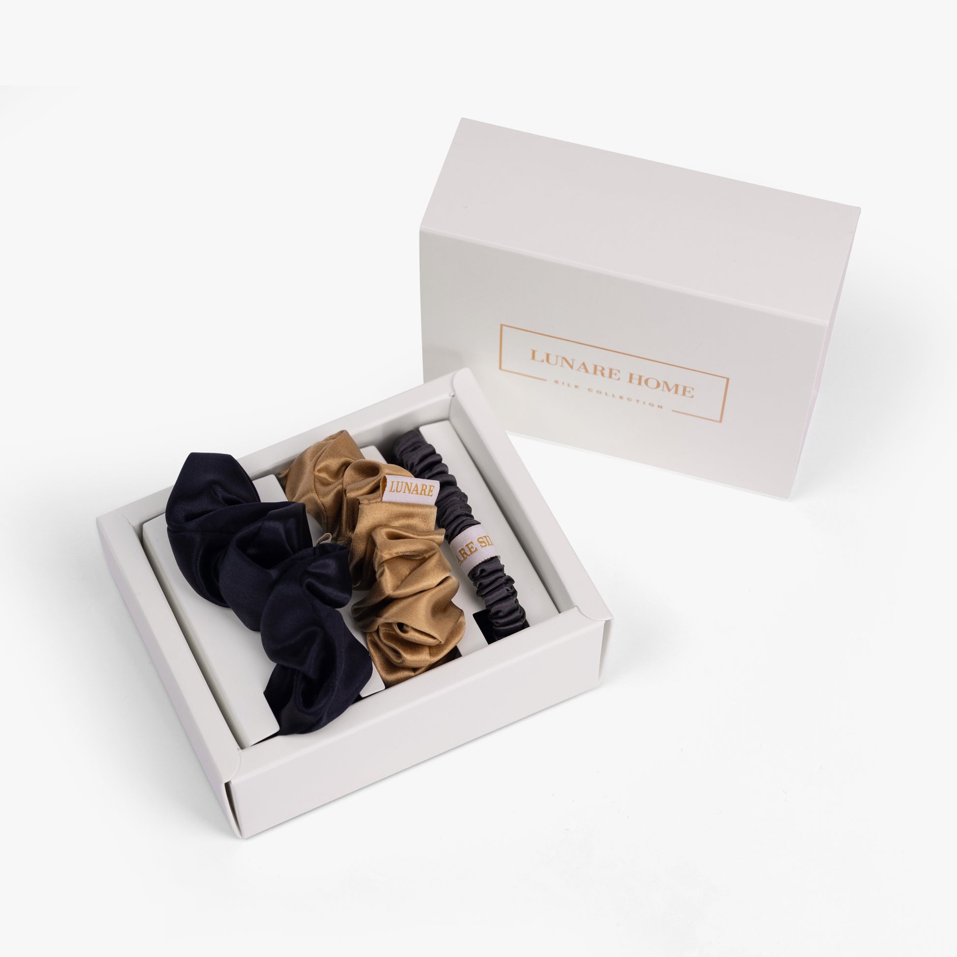 Classic neutral silk scrunchies in open gift box with Lunare Home lid
