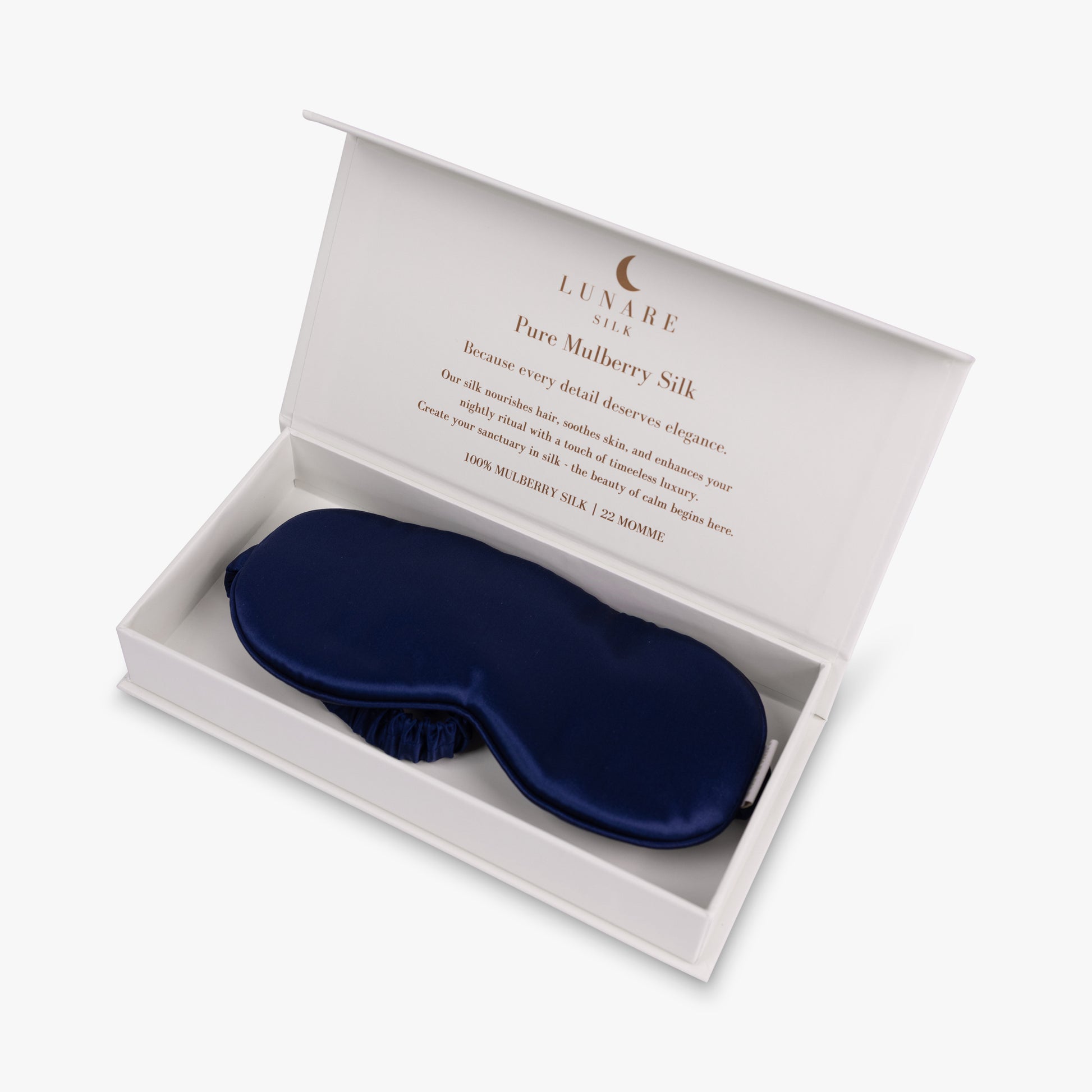 Navy blue silk eye mask in open gift box
