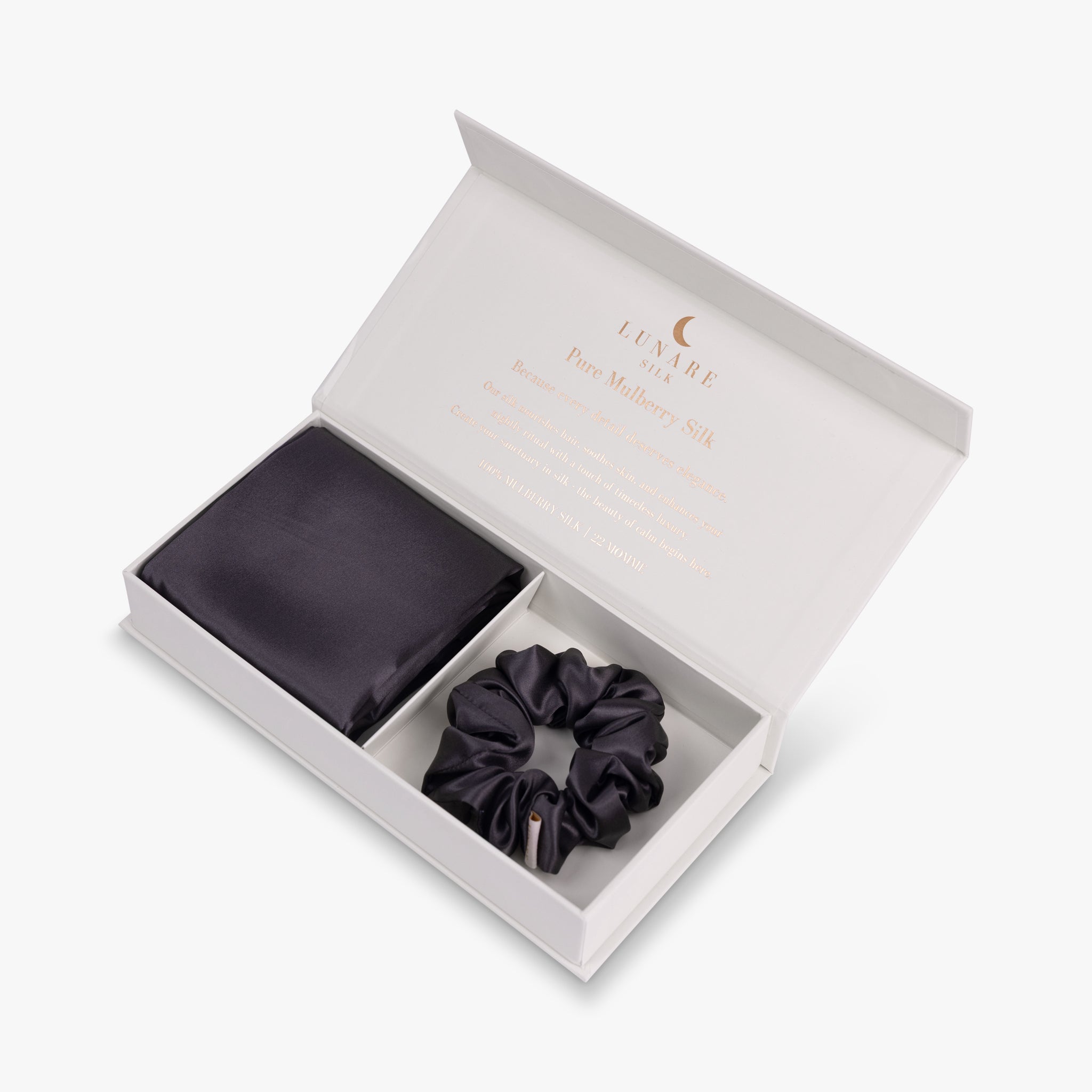 Dark grey essential silk bundle in open box with pillowcase and scrunchie
