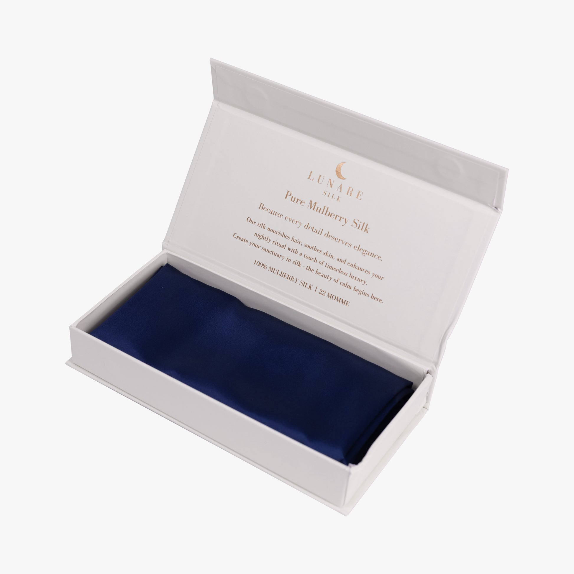 Navy blue silk pillowcase in open gift box
