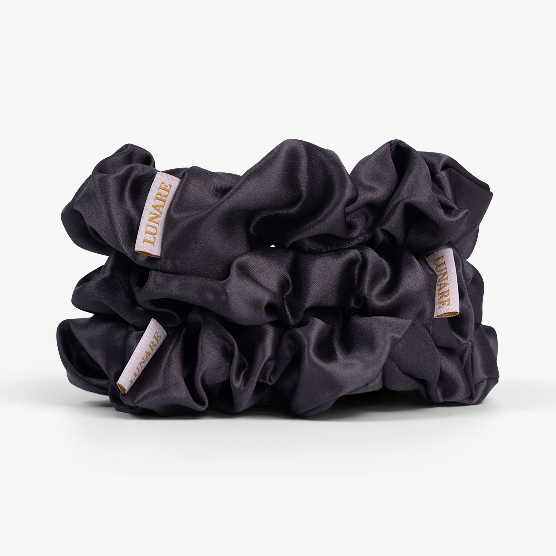 Dark grey large silk scrunchie on white background
