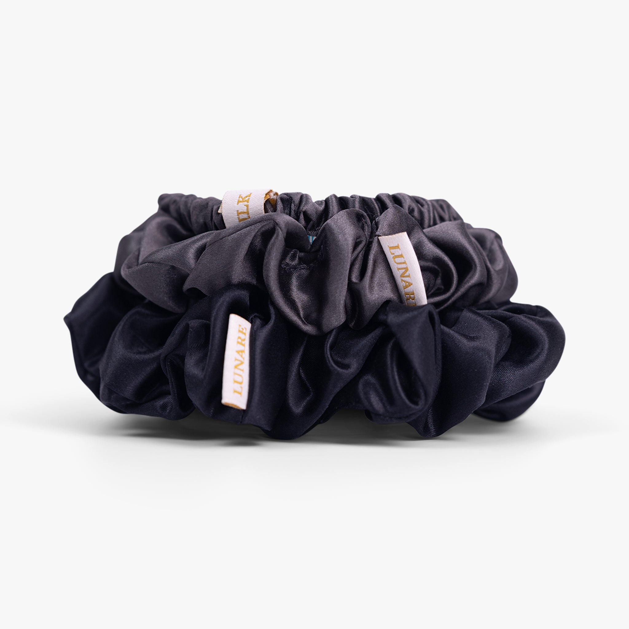 Deep neutral silk scrunchies close-up view
