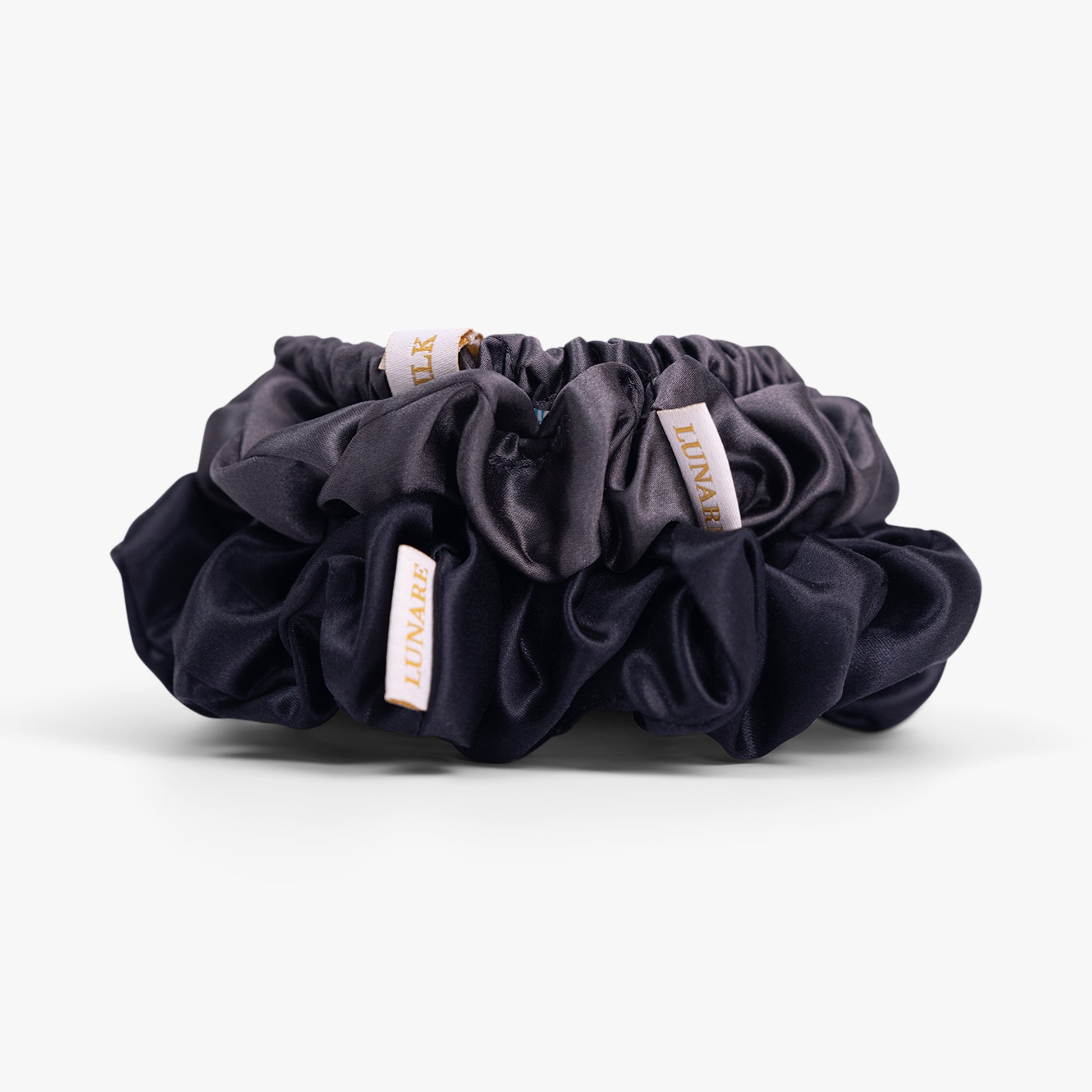 Deep neutral silk scrunchies close-up view
