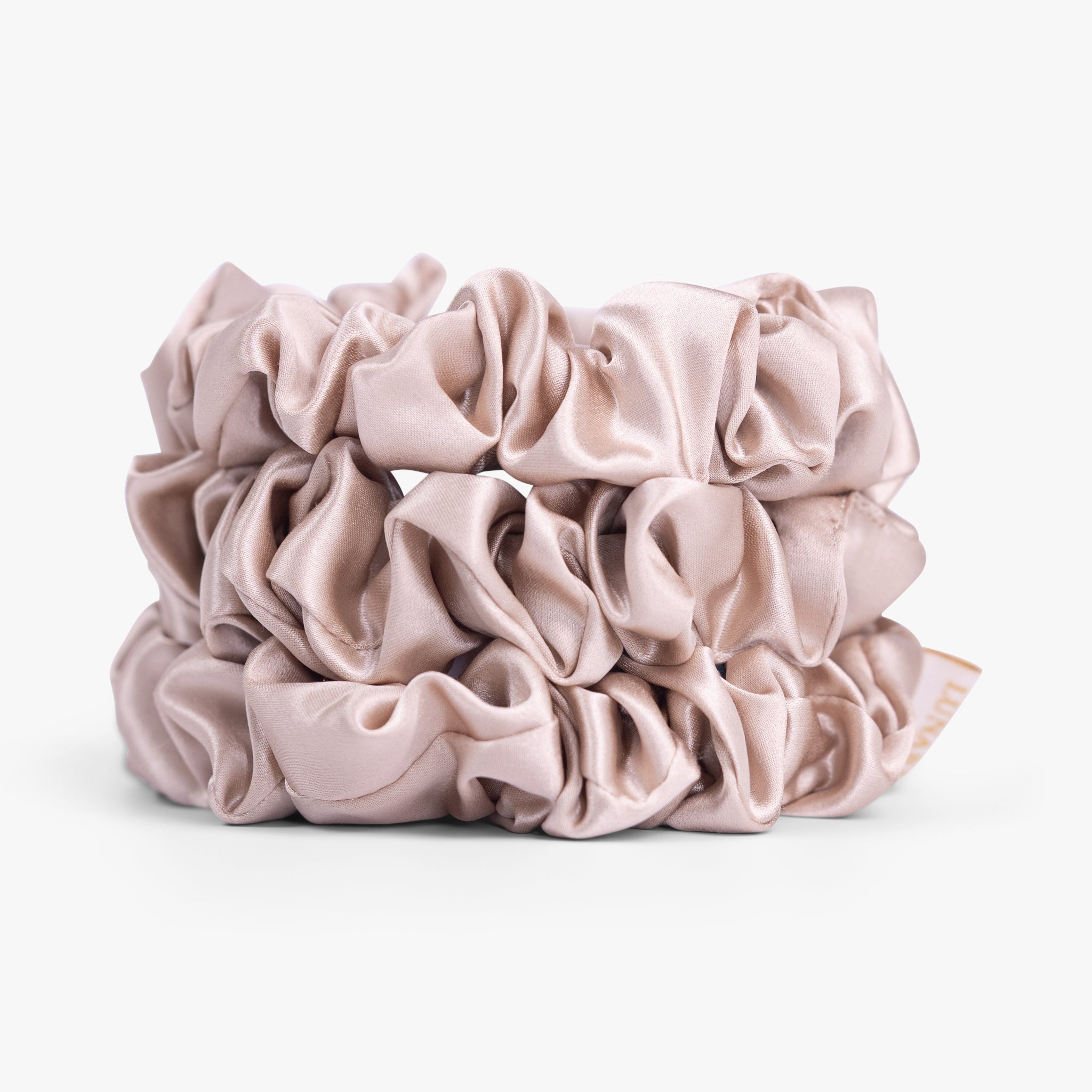 Champagne large silk scrunchie on white background
