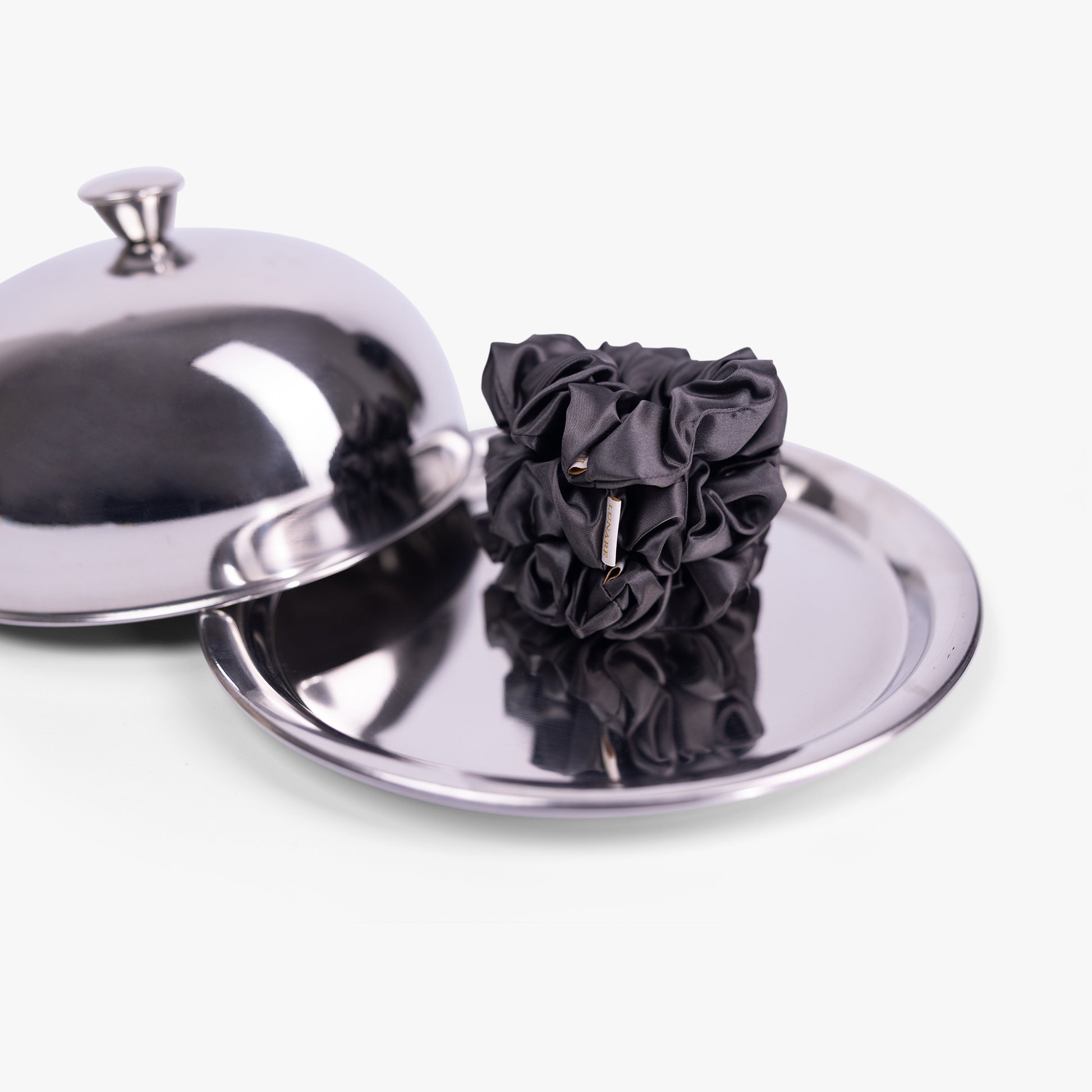 Dark grey large silk scrunchie on silver tray with lid
