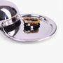 Set of hair ties on a metallic surface with a reflective lid.