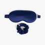 Navy blue care silk bundle with eye mask and scrunchie on white background
