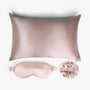 Champagne ritual silk bundle with pillowcase, eye mask and scrunchie on white background

