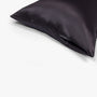 Dark grey silk pillowcase with zipper closure detail
