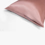 Cherry pink silk pillowcase with zipper closure detail
