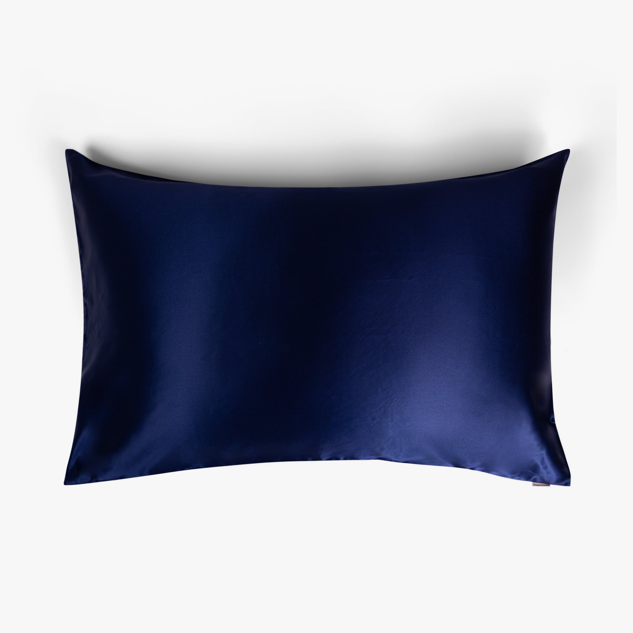 Navy blue silk pillowcase on white background
