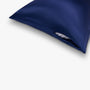 Navy blue silk pillowcase with zipper closure detail
